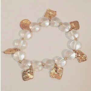 Stunning stretchy bracelet features clear beads and gold flake charms